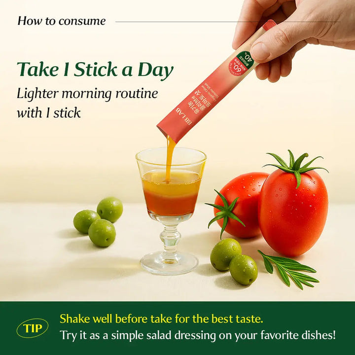 A hand holds and pours a pinkish-orange liquid supplement stick packet into a glass of orange juice, with tomatoes and olives on a light surface. Text explains how to consume one stick daily, and a green tip at the bottom says to shake well before use.