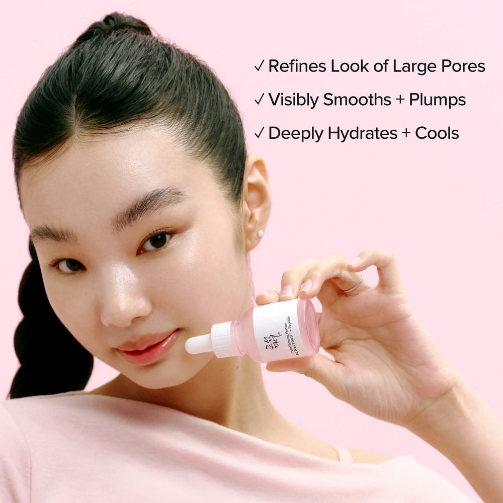 Woman holding a BEAUTY OF JOSEON Pore Firming Serum with product benefits listed on a pink background