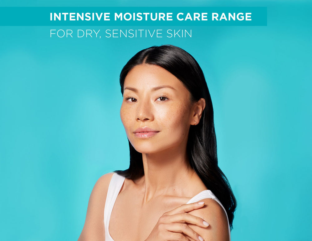 Woman with long dark hair against a blue background with text about intensive moisture care for dry, sensitive skin.