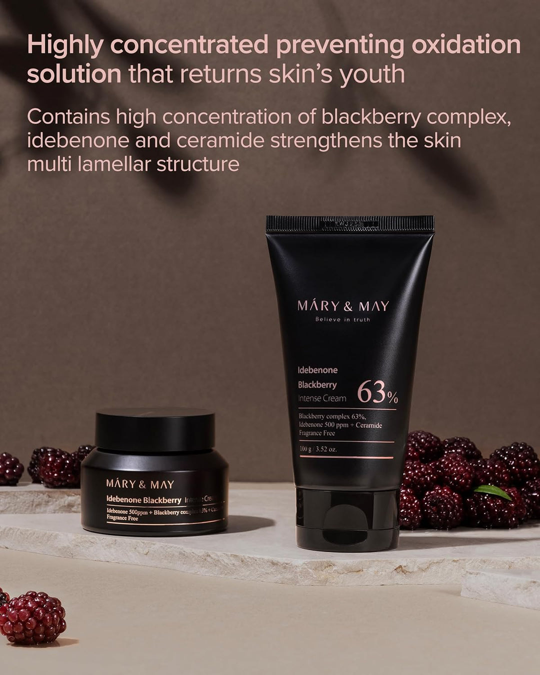 Mary & May skincare products shown on a beige surface against a brown backdrop, with blackberry props and promotional text at the top. The set includes a blackberry cream jar and a blackberry cream tube labeled 63% with visible Mary & May branding.