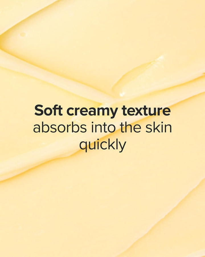 A close-up of a pale creamy yellow cosmetic texture with overlaid text reading 'Soft creamy texture absorbs into the skin quickly'. No physical product container is visible.